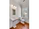 Bathroom featuring pedestal sink, toilet, window, and hardwood floors at 26 Saturday Rd, Mount Pleasant, SC 29464