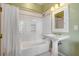 Cozy bathroom featuring a shower-tub combo with white tile surround and pedestal sink at 26 Saturday Rd, Mount Pleasant, SC 29464