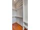 Walk-in closet featuring custom shelving and hardwood floors at 26 Saturday Rd, Mount Pleasant, SC 29464