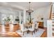 Open-concept dining room with hardwood floors, staircase, and a view into the living room at 26 Saturday Rd, Mount Pleasant, SC 29464