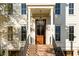 Striking entrance featuring a wood door, brick steps, black iron railing and detailed trim at 26 Saturday Rd, Mount Pleasant, SC 29464