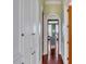 Hallway with hardwood floors and custom built-in cabinets, leading into a room with beautiful arched doorways at 26 Saturday Rd, Mount Pleasant, SC 29464