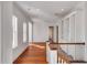 Upstairs hallway features hardwood floors, natural light, and custom shelving at 26 Saturday Rd, Mount Pleasant, SC 29464