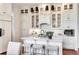 Bright kitchen boasts white cabinets, marble countertops, and a stylish island with seating at 26 Saturday Rd, Mount Pleasant, SC 29464
