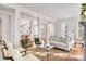 Bright living room with hardwood floors, large windows, and stylish decor at 26 Saturday Rd, Mount Pleasant, SC 29464