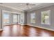 Spacious living room with views, large windows, and stylish hardwood floors at 26 Saturday Rd, Mount Pleasant, SC 29464