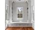 Bright living room with a window seat, custom built-ins, and warm hardwood floors at 26 Saturday Rd, Mount Pleasant, SC 29464