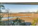Beautiful view of the marshland from inside the property's windows, with cranes in the background at 26 Saturday Rd, Mount Pleasant, SC 29464