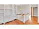 Second floor landing with built-in shelves and staircase with wood railing at 26 Saturday Rd, Mount Pleasant, SC 29464