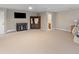 Second bedroom featuring tan carpet, a TV and bar area, and an en suite bathroom entrance at 2648 Augustus St, Daniel Island, SC 29492