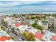 Stunning aerial view of colorful townhouses with rooftop terraces near the ocean, offering luxurious living at 29 Broad St # A C, Charleston, SC 29401