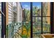 Charming balcony with ornate green railings offering serene views of lush greenery and the surrounding neighborhood at 29 Broad St # A C, Charleston, SC 29401
