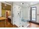 Bathroom featuring a modern glass shower with white tile and hardwood floors at 29 Broad St # A C, Charleston, SC 29401