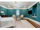 Elegant bedroom featuring a chandelier, sitting area, and striking teal walls with decorative molding at 29 Broad St # A C, Charleston, SC 29401