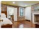 Spacious bedroom with hardwood floors, brick accent wall, and ensuite bathroom with a glass shower at 29 Broad St # A C, Charleston, SC 29401