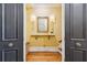 Inviting foyer featuring a hardwood floors, decorative mirror, and wall sconces, creating a warm entry at 29 Broad St # A C, Charleston, SC 29401