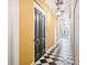 Elegant hallway with black and white tiled floors, lantern lighting, and an inviting atmosphere at 29 Broad St # A C, Charleston, SC 29401
