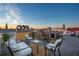 Charming rooftop deck featuring comfortable seating and scenic city views under a clear blue sky at 29 Broad St # A C, Charleston, SC 29401