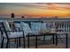 Cozy rooftop seating arrangement with stylish cushions and a table, perfect for enjoying the evening sky at 29 Broad St # A C, Charleston, SC 29401