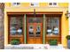 Charming commercial storefront with large windows, wooden doors, and manicured planters enhancing curb appeal at 29 Broad St # A C, Charleston, SC 29401