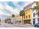 Historic street featuring charming townhouses with colorful exteriors and lush palm trees adding to curb appeal at 29 Broad St # A C, Charleston, SC 29401