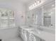 Bright bathroom featuring double sinks, large mirror, and custom vanity at 309 N Civitas St, Mount Pleasant, SC 29464