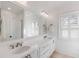 Bright bathroom featuring a double vanity, custom cabinetry, and plantation shutters at 309 N Civitas St, Mount Pleasant, SC 29464