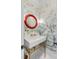 Elegant powder room with decorative wallpaper, statement mirror, and pedestal sink at 309 N Civitas St, Mount Pleasant, SC 29464