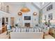 Bright living room with high ceilings, modern furnishings, and a cozy fireplace at 309 N Civitas St, Mount Pleasant, SC 29464