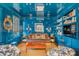 Chic living room with glossy blue walls, custom bookshelves, and unique decor at 309 N Civitas St, Mount Pleasant, SC 29464