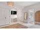 Well-lit bedroom with desk, television, and ensuite bathroom access at 309 N Civitas St, Mount Pleasant, SC 29464