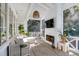 Relaxing screened-in porch with a fireplace, television, comfortable seating, and views of the outdoors at 309 N Civitas St, Mount Pleasant, SC 29464