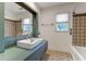 Bathroom featuring modern vanity, tiled shower, and natural light from the window, creating a refreshing and stylish space at 339 Cabell St, Charleston, SC 29407