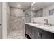 Modern bathroom features glass shower enclosure, dual sink vanity with marble top, and elegant tiling at 339 Cabell St, Charleston, SC 29407
