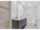 Bathroom with tiled shower, glass door, and double sink vanity with marble countertop at 339 Cabell St, Charleston, SC 29407