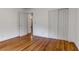 Bright bedroom with pristine hardwood floors, closet space, and an open doorway to a hallway at 339 Cabell St, Charleston, SC 29407