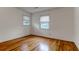 Cozy bedroom with natural light, hardwood floors, and views of the outdoors through two bright windows at 339 Cabell St, Charleston, SC 29407