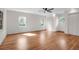 Spacious bedroom with hardwood floors, ample natural light from three windows, and a ceiling fan at 339 Cabell St, Charleston, SC 29407