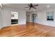 A sunlit bedroom with rich hardwood floors, a ceiling fan, and access to an adjacent bath with marble vanity at 339 Cabell St, Charleston, SC 29407