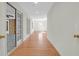 Hallway featuring hardwood floors, doors, and natural light, offers a seamless transition to the home's rooms at 339 Cabell St, Charleston, SC 29407