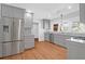 Well-lit kitchen features gray cabinets, stainless steel refrigerator and granite countertops at 339 Cabell St, Charleston, SC 29407