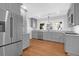 Beautiful kitchen showcasing stainless steel appliances, gray cabinets, and a large window at 339 Cabell St, Charleston, SC 29407