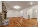 Open-concept living room with hardwood floors and a brick fireplace at 339 Cabell St, Charleston, SC 29407