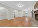 Open living room showcasing hardwood floors, arched doorways, a fireplace, and ample space for versatile arrangements at 339 Cabell St, Charleston, SC 29407
