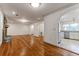 Open-concept living room with hardwood floors, brick fireplace, and kitchen view at 339 Cabell St, Charleston, SC 29407