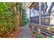Charming view of a screened in back porch accessible by a stone pathway and lush vegetation at 339 Cabell St, Charleston, SC 29407
