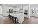 Modern white kitchen featuring a large island, stainless steel appliances, and stylish fixtures at 360 Citrus Dr, Summerville, SC 29486