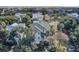An aerial view showcasing a home nestled among mature trees, with the beach visible in the background at 4000 Cameron Blvd, Isle of Palms, SC 29451