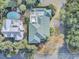 An aerial view of a stunning house with a distinctive green roof, swimming pool, and expansive outdoor lounge areas at 4000 Cameron Blvd, Isle of Palms, SC 29451