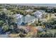 An aerial view of a charming home surrounded by lush foliage with the beach visible in the background at 4000 Cameron Blvd, Isle of Palms, SC 29451